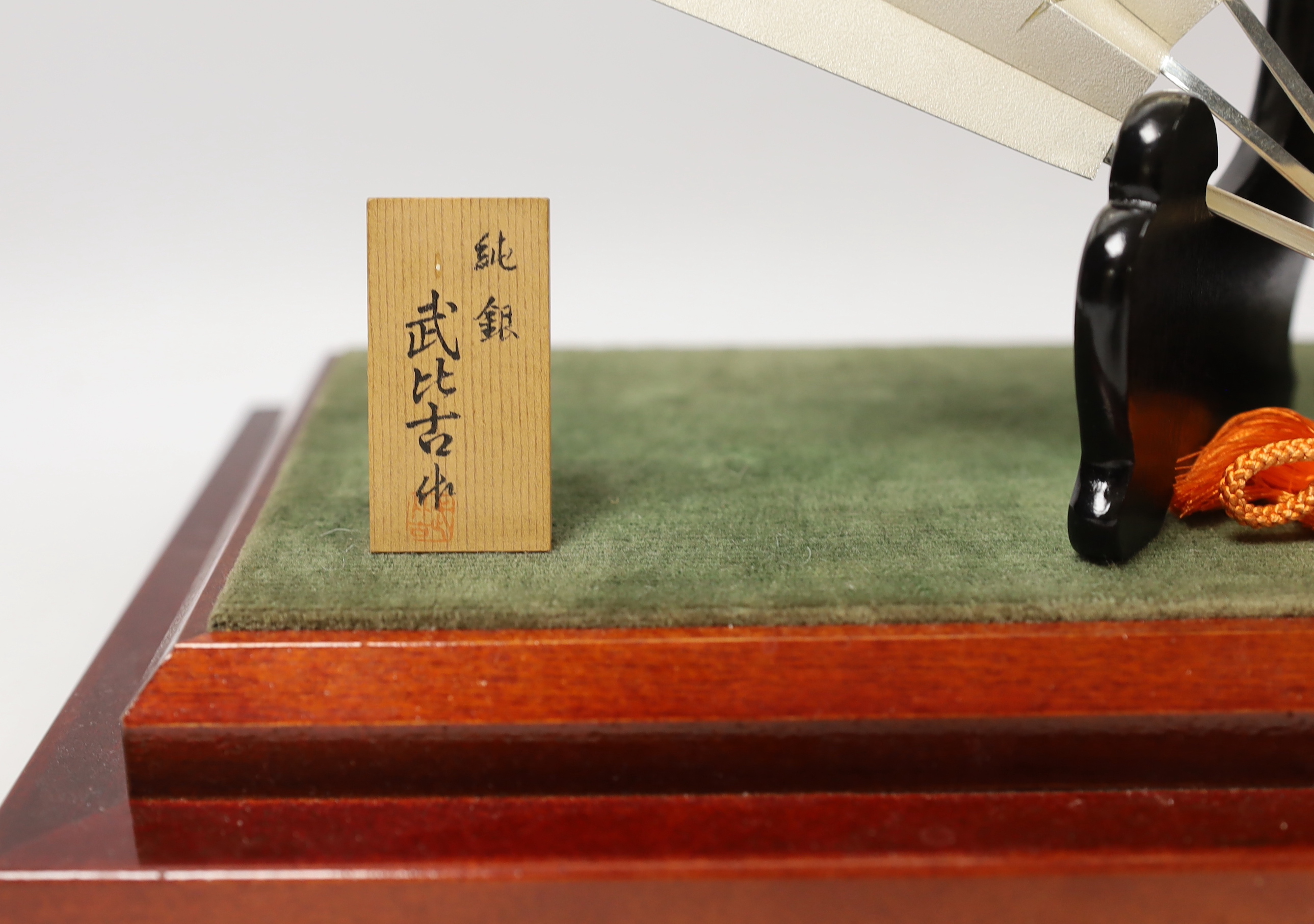 A Japanese white metal fan ornament on stand, signed, 24cm wide